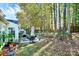 Backyard with patio, landscaping, and wooded backdrop at 1846 Colin Creek Ln, Charlotte, NC 28214