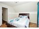 Bedroom with wooden bed, teal curtains, and hardwood floors at 1846 Colin Creek Ln, Charlotte, NC 28214
