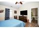 Bedroom with large TV, ceiling fan, and access to upper hallway at 1846 Colin Creek Ln, Charlotte, NC 28214