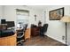 Home office with wooden desk, computer, and printer at 1846 Colin Creek Ln, Charlotte, NC 28214