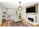 Living room featuring a fireplace, hardwood floors, and comfortable seating at 1846 Colin Creek Ln, Charlotte, NC 28214