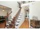 Elegant staircase with dark wood railings and a patterned runner at 1846 Colin Creek Ln, Charlotte, NC 28214