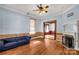 Spacious living room with hardwood floors, fireplace, and ceiling fan at 307 Kings Mountain St, Clover, SC 29710