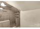 Large tiled shower with glass enclosure and shelving at 307 Kings Mountain St, Clover, SC 29710