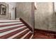 Wooden staircase with white risers and brown handrail at 307 Kings Mountain St, Clover, SC 29710