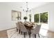 Bright dining room features a wooden table, six chairs, and sliding glass doors leading to the backyard at 3840 Lake Rd, Charlotte, NC 28269