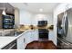 Modern kitchen with stainless steel appliances and white cabinets at 401 N Church St # 406, Charlotte, NC 28202