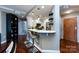 Modern kitchen features a breakfast bar, stainless steel appliances, and hardwood floors at 401 N Church St # 406, Charlotte, NC 28202
