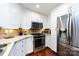 Modern kitchen with stainless steel appliances and white cabinets at 401 N Church St # 406, Charlotte, NC 28202