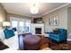 Living room with fireplace, hardwood floors, and access to a balcony at 401 N Church St # 406, Charlotte, NC 28202
