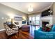 Open living room with hardwood floors, fireplace, and comfortable seating at 401 N Church St # 406, Charlotte, NC 28202