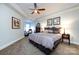 Large main bedroom features plush carpeting, a ceiling fan, and ample natural light at 401 N Church St # 406, Charlotte, NC 28202
