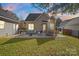 Spacious backyard with patio furniture and fire pit at 8225 Ballymore Ct, Huntersville, NC 28078