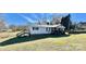 Single-wide mobile home with deck, steps, and a spacious yard at 940 Devil Track Rd, Taylorsville, NC 28681