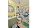 Bathroom with dinosaur-themed shower curtain and a small vanity at 940 Devil Track Rd, Taylorsville, NC 28681
