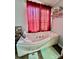 Bathroom with corner jetted tub and red curtains at 940 Devil Track Rd, Taylorsville, NC 28681