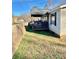 Home exterior showcasing a covered patio and retaining wall at 940 Devil Track Rd, Taylorsville, NC 28681