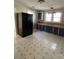 Kitchen with dark cabinets, linoleum floor, and appliances at 1008 Rockland Sw Cir, Concord, NC 28027