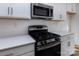 Stainless steel appliances and white cabinets in a modern kitchen at 2212 Noble Townes Way, Charlotte, NC 28262