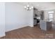 Open concept dining room with hardwood floors and a chandelier at 2216 Noble Townes Way, Charlotte, NC 28262