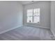 Bright bedroom with neutral carpeting and a window at 2220 Noble Townes Way, Charlotte, NC 28262