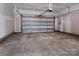 Attached garage with open door and concrete floor at 2220 Noble Townes Way, Charlotte, NC 28262