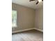 Well-lit bedroom featuring neutral walls and vinyl flooring at 3010 Forbes Rd, Gastonia, NC 28056