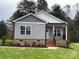 Gray sided home with brick base and a front porch at 3010 Forbes Rd, Gastonia, NC 28056