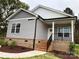 Gray sided home with brick base and a front porch at 3010 Forbes Rd, Gastonia, NC 28056