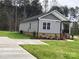 Gray sided home with brick base and side yard at 3010 Forbes Rd, Gastonia, NC 28056
