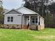 Gray sided home with brick base and a front porch at 3010 Forbes Rd, Gastonia, NC 28056