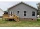 Gray house exterior with wooden deck and steps, surrounded by a grassy yard at 3010 Forbes Rd, Gastonia, NC 28056
