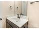 Small bathroom with dark brown vanity and a single sink at 9036 Bradstreet Commons Way, Charlotte, NC 28215