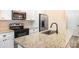 Modern kitchen with granite countertops and a black faucet at 9036 Bradstreet Commons Way, Charlotte, NC 28215