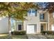 Tan two-story townhome with attached garage and landscaping at 9036 Bradstreet Commons Way, Charlotte, NC 28215