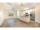 Open kitchen with granite island, stainless steel appliances, and hardwood floors at 9036 Bradstreet Commons Way, Charlotte, NC 28215