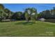 Scenic pond with a fountain, grassy area, picnic table, and disc golf at 12006 Woodside Falls Rd, Pineville, NC 28134