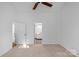Bedroom with ceiling fan, carpet, and access to bathroom at 12006 Woodside Falls Rd, Pineville, NC 28134