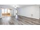 Living room with sliding glass doors leading to a sunroom and wood-look floors at 1541 Hunt Club Ct, Rock Hill, SC 29732