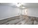 Spacious living room with wood-look flooring and ceiling fan at 1541 Hunt Club Ct, Rock Hill, SC 29732