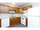 Kitchen with wood cabinets, white appliances, and vinyl flooring at 1541 Hunt Club Ct, Rock Hill, SC 29732