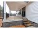 Covered back porch with stone base and a view of the wooded backyard at 1451 Glasscock Rd # 9, Rock Hill, SC 29730