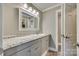 Updated bathroom with gray vanity, granite countertop and framed mirror at 1830 Ebenezer Rd, Rock Hill, SC 29732