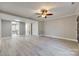 Open living space with light walls, ceiling fan and wood-look floors at 1830 Ebenezer Rd, Rock Hill, SC 29732