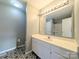 Bathroom with vanity, large mirror, and geometric tile floor at 2172 Robert Usher Rd, Lancaster, SC 29720