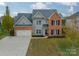 Two-story brick home with a two-car garage and landscaped yard at 10126 Loch Lomond Dr, Charlotte, NC 28278