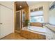 Spa-like bathroom featuring a soaking tub and walk-in shower at 10126 Loch Lomond Dr, Charlotte, NC 28278