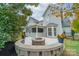 Spacious backyard patio with fire pit and screened porch at 10126 Loch Lomond Dr, Charlotte, NC 28278