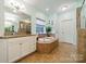 Relaxing bathroom with soaking tub and double vanity at 10126 Loch Lomond Dr, Charlotte, NC 28278