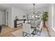 Dining room with modern light fixture, large table, and hardwood floors at 1320 Brook Rd, Charlotte, NC 28205